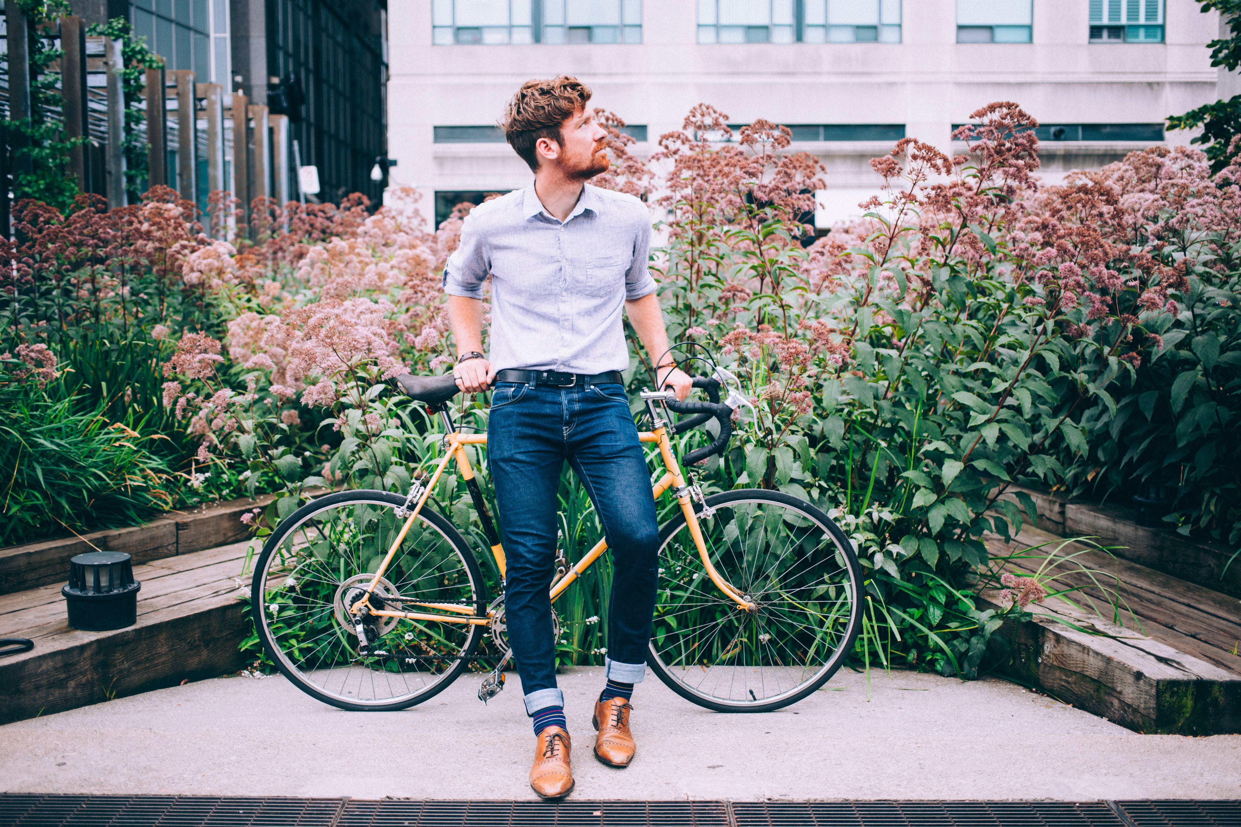 mens-fashion-man-in-shirt-and-jeans-leaning-on-bicycle.jpg
